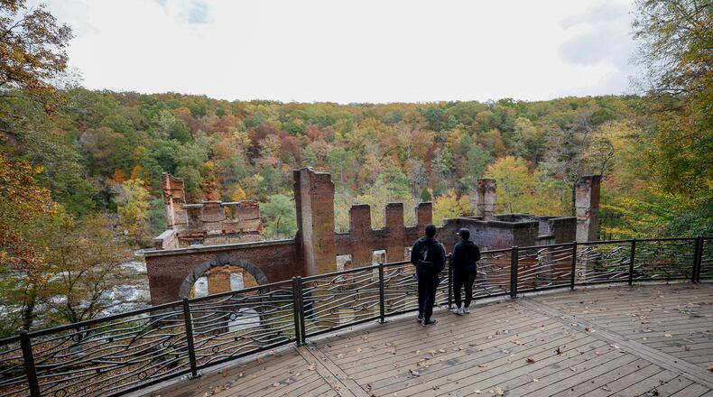 Park visitors take in the view overlooking the old paper mill by Sweetwater Creek State Park on Thursday, October 30, 2025. Georgia’s Board of Natural Resources is expected to double the entrance fee at state parks.
(Miguel Martinez/ AJC)