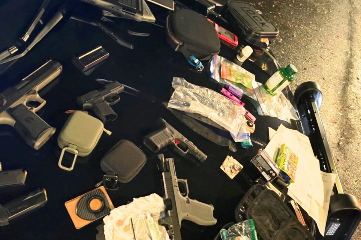 Police in Alpharetta found several handguns and a cache of illegal narcotics in a parked car on Thanksgiving morning. (Courtesy of the Alpharetta Police Department)