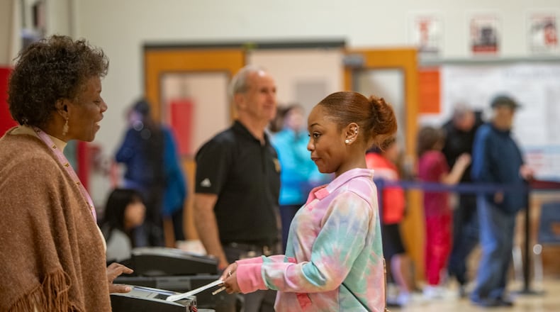 Gwinnett County voters, including Khameelah Hasan, cast their ballots on Election Day at W.J. Cooper Elementary School in Loganville. The state of Georgia was on track to break voter turnout records as presidential candidates Donald Trump and Kamala Harris went head to head in this swing state. (Jenni Girtman for The Atlanta Journal-Constitution)