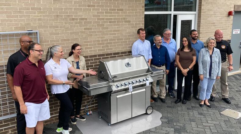 Recently 11 local Sandy Springs neighborhoods joined forces to donate a new grill to the fire station. (Courtesy City of Sandy Springs)