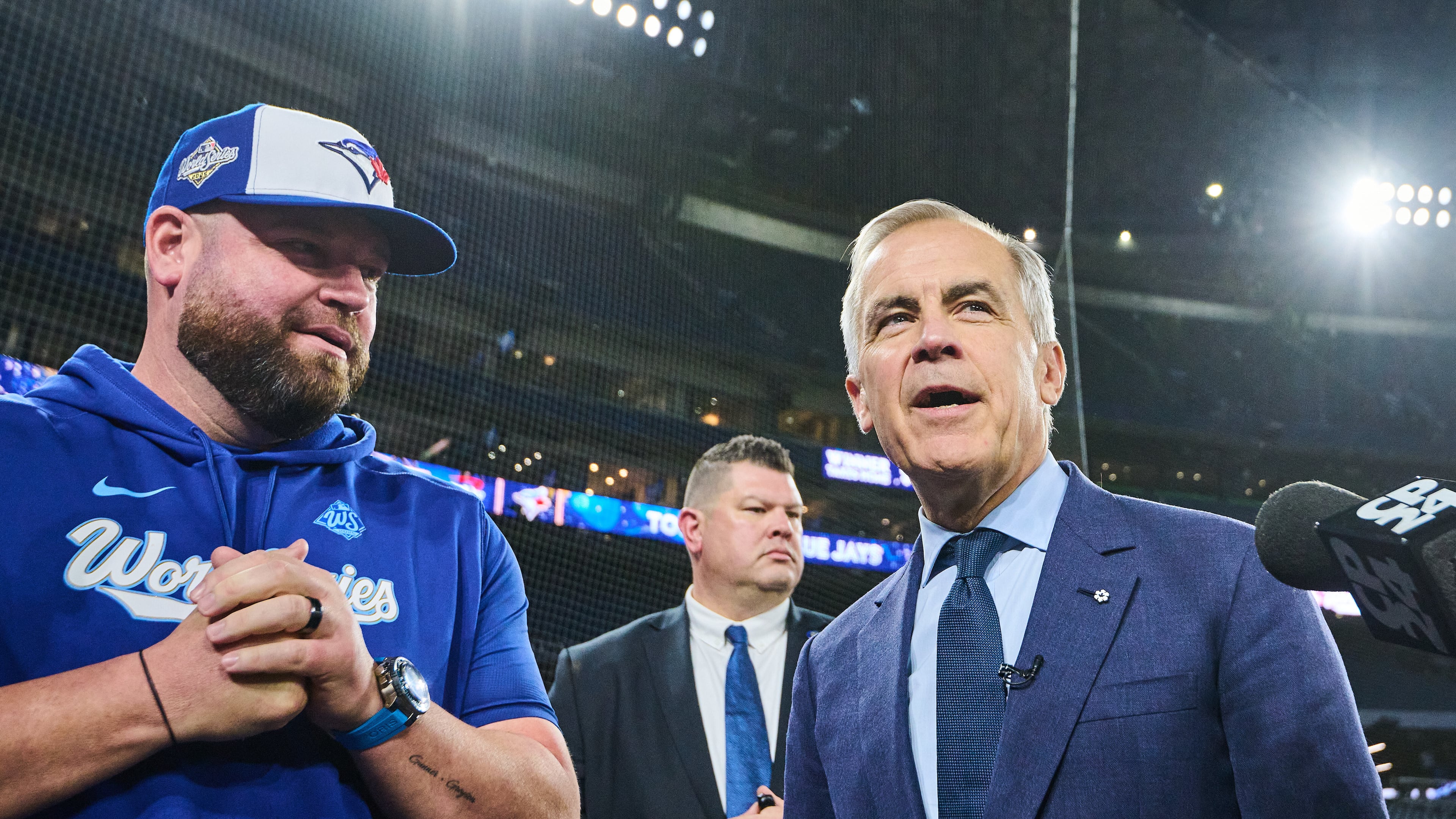 Canada's Prime Minister Mark Carney speaks to Toronto Blue Jays manager John Schneider as he visits the Blue Jays during baseball's World Series media day, Thursday, Oct. 23, 2025, in Toronto,. (Sammy Kogan/The Canadian Press via AP)