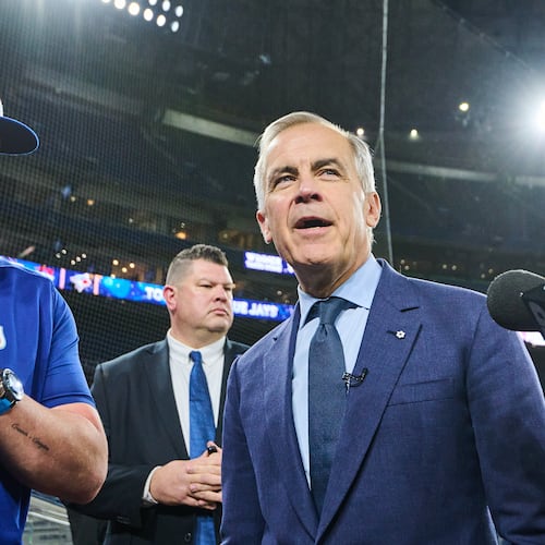 Canada's Prime Minister Mark Carney speaks to Toronto Blue Jays manager John Schneider as he visits the Blue Jays during baseball's World Series media day, Thursday, Oct. 23, 2025, in Toronto,. (Sammy Kogan/The Canadian Press via AP)