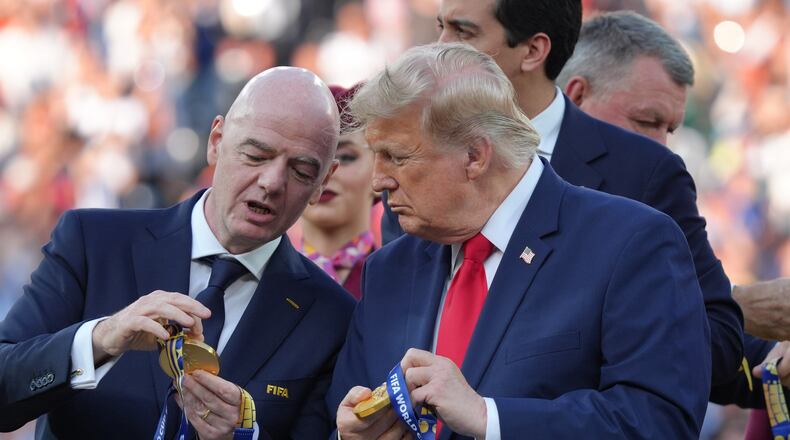 FIFA President Gianni Infantino, left, and President Donald Trump comment on the medals as they wait to congratulate the Spanish players after the World Cup final soccer match between Spain and Argentina in East Rutherford, N.J., near New York, Sunday, July 19, 2026. (AP Photo/Jacquelyn Martin)