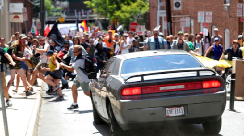A vehicle drives into a group of protesters demonstrating against a white nationalist rally in Charlottesville, Va., Saturday, Aug. 12, 2017. The nationalists were holding the rally to protest plans by the city of Charlottesville to remove a statue of Confederate Gen. Robert E. Lee. There were several hundred protesters marching in a long line when the car drove into a group of them.   /The Daily Progress via AP)
