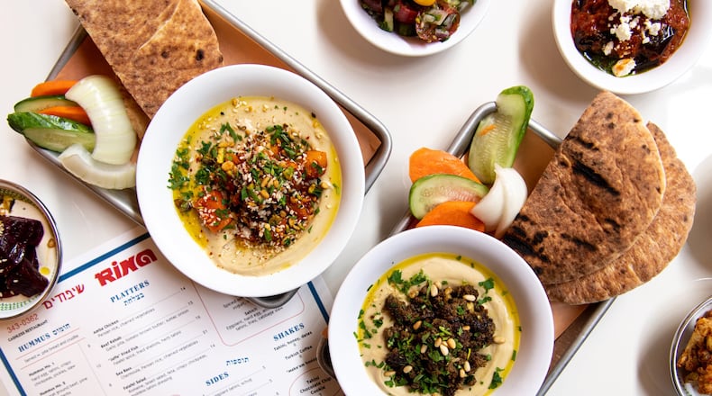Rina Hummus No. 3 with roasted spiced butternut, dukkah, and harissa, and Hummus No. 2 with Baharat ground beef, pine nuts, and herbs. Photo credit- Mia Yakel.