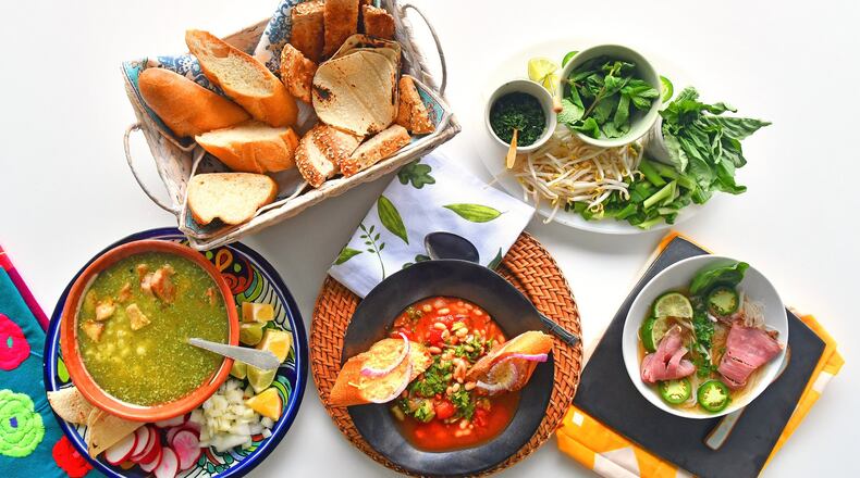Whether it’s rainy or just chilly, you can take comfort in soups such as (bottom row, from left) Mexican Green Posole, Easy Italian Ribollita and Vietnamese Weeknight Beef Pho. STYLING BY LISA HANSON / CONTRIBUTED BY CHRIS HUNT PHOTOGRAPHY