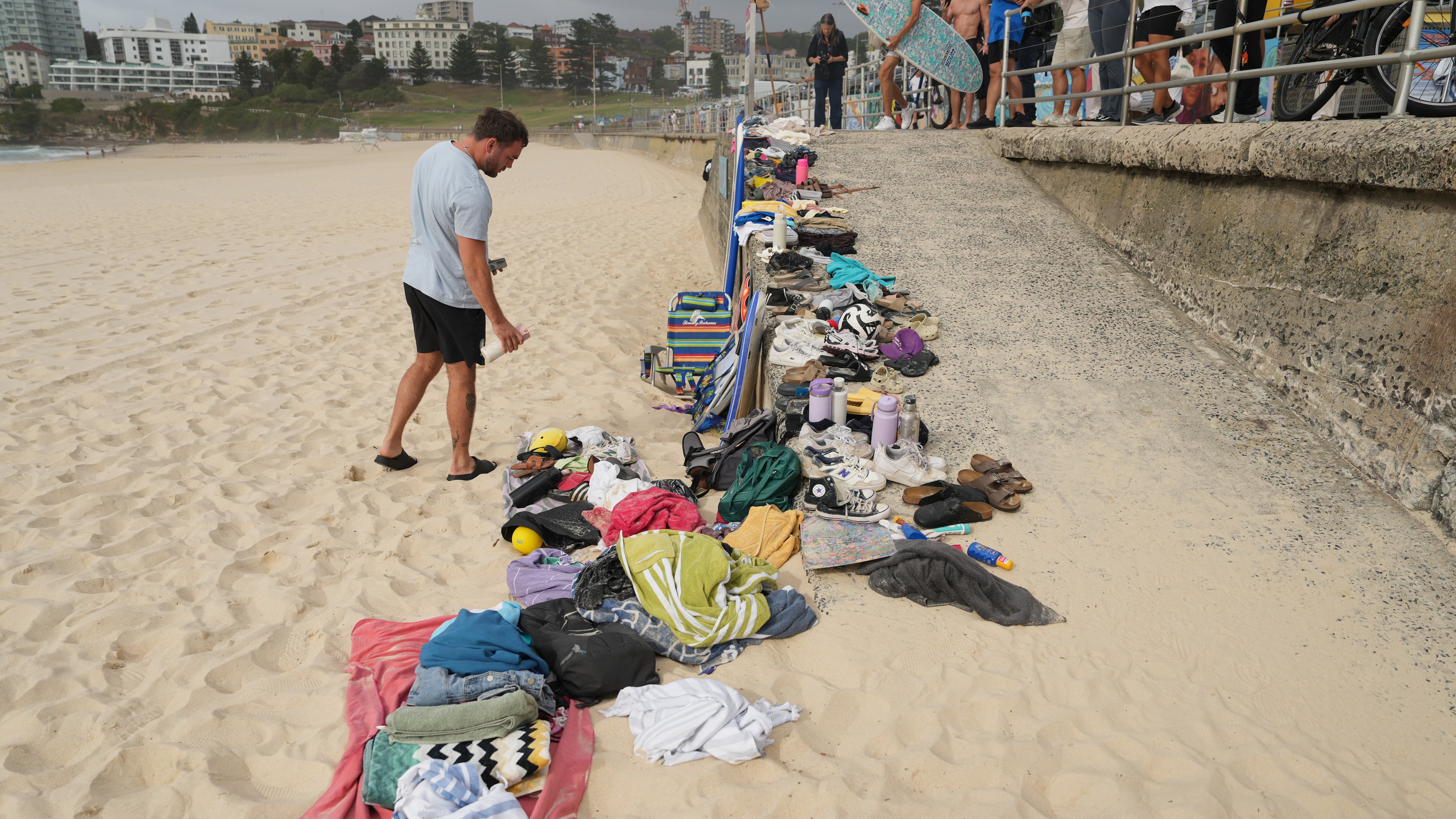 A man looks at belongings stacked up following a shooting the day prior at Sydney's Bondi Beach, Monday, Dec. 15, 2025. (AP Photo/Mark Baker)