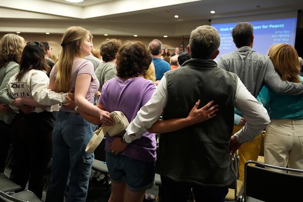People attend a vigil at the Jewish Community Center of Greater Kansas City for Sarah Milgrim and Yaron Lischinsky, Israeli Embassy staff members who were shot and killed while leaving an event at a Jewish museum in Washington, Thursday, May 22, 2025, in Overland Park, Kan. (AP Photo/Charlie Riedel)