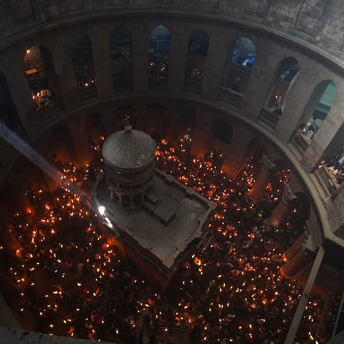 FILE - Christian Orthodox pilgrims hold up candles during the Holy Fire ceremony, at the Church of the Holy Sepulcher in the Old City of Jerusalem, Saturday, April 11, 2026. (AP Photo/Mahmoud Illean, File)