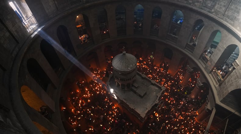FILE - Christian Orthodox pilgrims hold up candles during the Holy Fire ceremony, at the Church of the Holy Sepulcher in the Old City of Jerusalem, Saturday, April 11, 2026. (AP Photo/Mahmoud Illean, File)