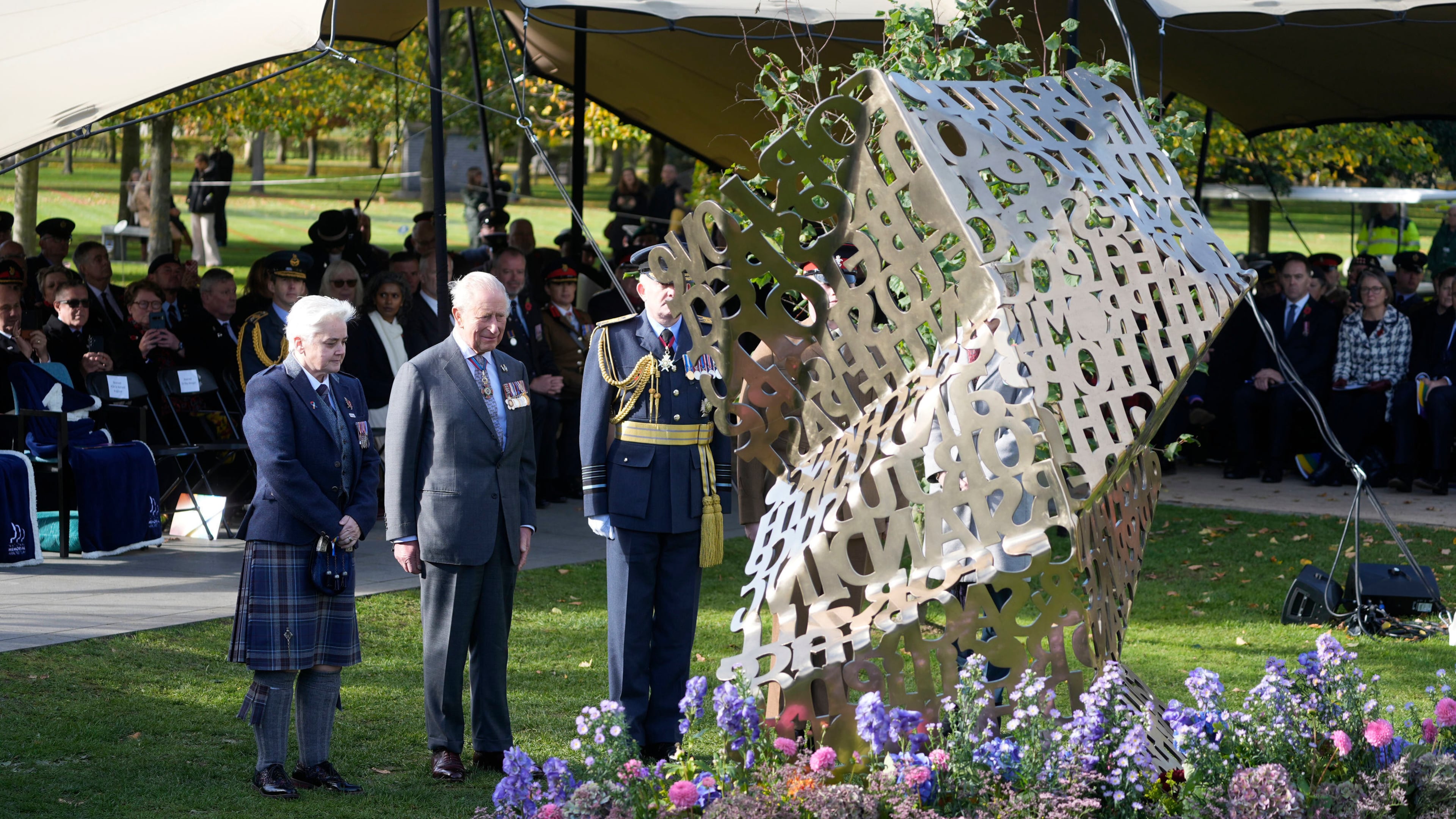 King Charles III stands during a visit to the National Memorial Arboretum in Alrewas, Staffordshire, for the dedication ceremony of the LGBT+ Armed Forces memorial, the UK's first national memorial commemorating LGBT+ people who have served and continue to serve in the military, Monday, Oct. 27, 2025. (Peter Byrne/PA via AP)