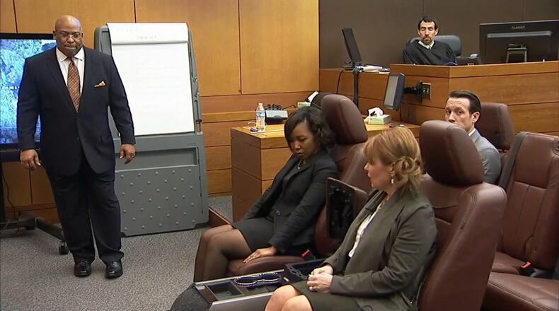 Witness Dani Jo Carter, in foreground, tells lead prosecutor Clint Rucker, at left, how Diane McIver passed the gun back to Tex on the night the Diane was shot. Carter and two other DAs are seated in a mock-up of the McIvers' SUV interior. The demonstration was part of Carter's testimony during Tex McIver's murder trial on March 19, 2018 at the Fulton County Courthouse. (Channel 2 Action News)