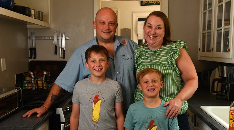 Chef Nick Melvin poses with his wife, Kristen, and sons Pern (left) and Lyle, in the kitchen of their home in Atlanta's Lake Claire neighborhood. (CHRIS HUNT FOR THE ATLANTA JOURNAL-CONSTITUTION)
