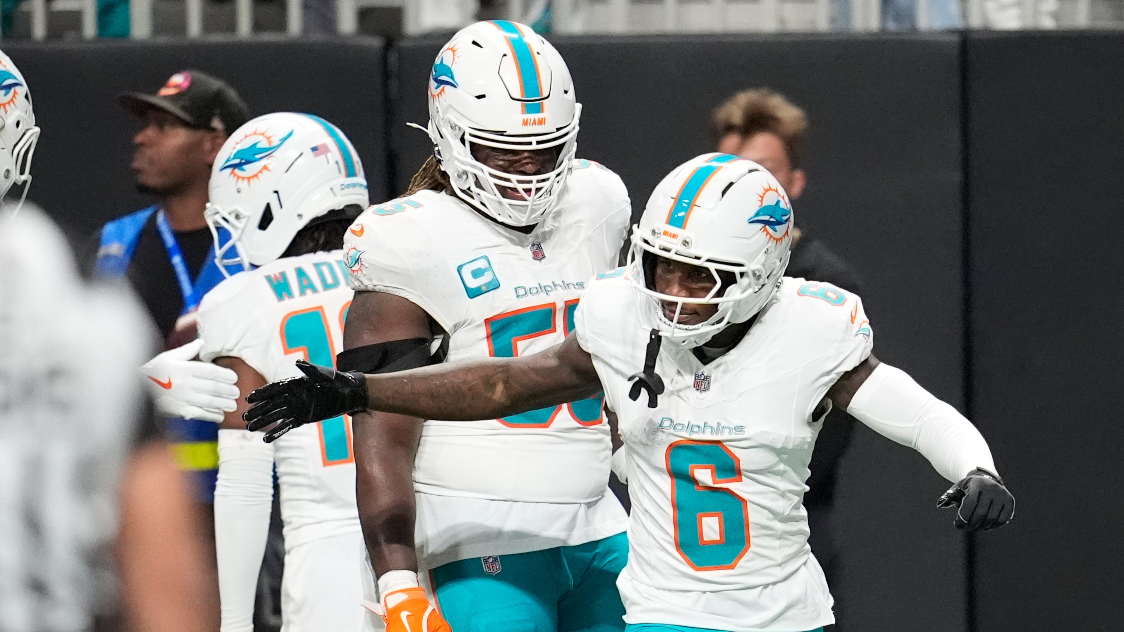 Miami Dolphins wide receiver Malik Washington (6) is congratulated after scoring a touchdown during the first half of an NFL football game against the Atlanta Falcons, Sunday, Oct. 26, 2025, in Atlanta. (AP Photo/Mike Stewart)