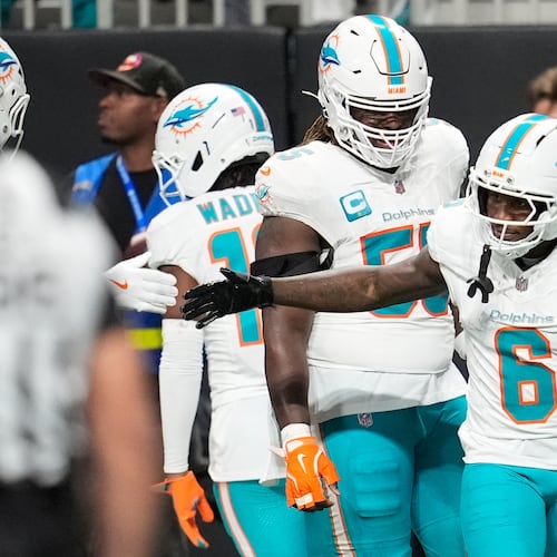 Miami Dolphins wide receiver Malik Washington (6) is congratulated after scoring a touchdown during the first half of an NFL football game against the Atlanta Falcons, Sunday, Oct. 26, 2025, in Atlanta. (AP Photo/Mike Stewart)