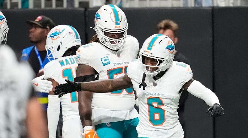 Miami Dolphins wide receiver Malik Washington (6) is congratulated after scoring a touchdown during the first half of an NFL football game against the Atlanta Falcons, Sunday, Oct. 26, 2025, in Atlanta. (AP Photo/Mike Stewart)