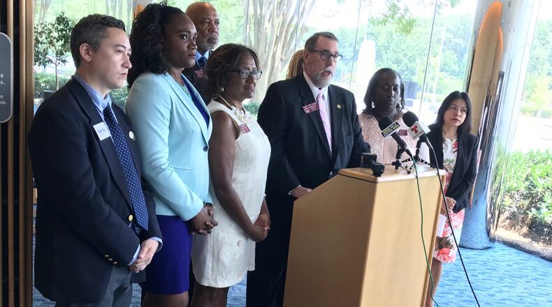 Rep. Pedro Marin (at podium), other Democratic lawmakers representing parts of Gwinnett and candidates for state and local offices held a press conference Wednesday asking the county commission to reconsider delaying a MARTA referendum until March. TYLER ESTEP / TYLER.ESTEP@AJC.COM