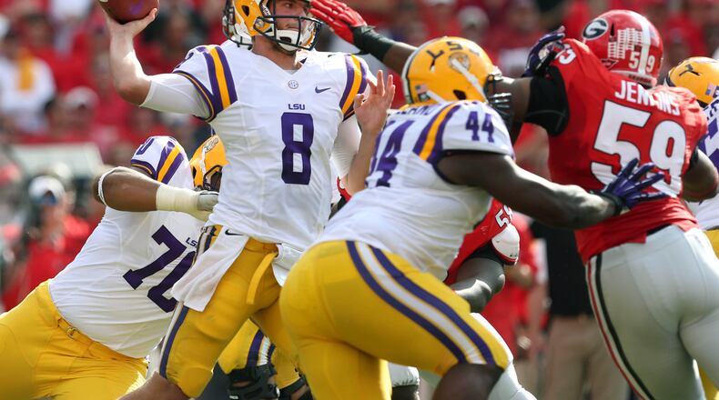 September 28, 2013 - Athens, Ga: Louisiana State University University quarterback Zach Mettenberger (8) attempts a pass under pressure from University of Georgia linebacker Jordan Jenkins, right, during Georgia's 44-41 win over Louisiana State University at Sanford Stadium Saturday afternoon in Athens, Ga., September 28, 2013. JASON GETZ / JGETZ@AJC.COM Zach Mettenberger submitted a suspicious urine sample at the NFL draft combine. (Jason Getz/AJC