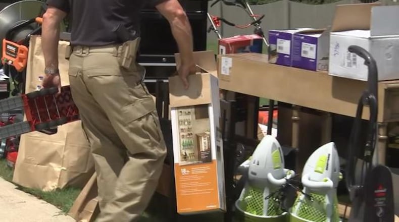 The GBI confiscated dozens of items from the home of a former supervisor accused of illegally using her purchasing card.