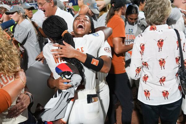 Texas' Adayah Wallace, front, and Kayden Henry, back, celebrate after winning the Women's College World Series softball championship against Texas Tech in Oklahoma City, Friday, June 6, 2025. (AP Photo/Kyle Phillips)