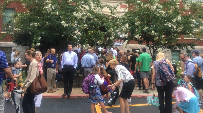 Students and parents rushed through the rain into Oakhurst Elementary School on Wednesday morning for the first day of the 2018-2019 school year.