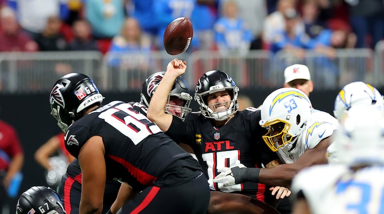 Otito Ogbonnia (93) of the Los Angeles Chargers forces a fumble against Kirk Cousins (18) of the Atlanta Falcons during the fourth quarter at Mercedes-Benz Stadium on Sunday, Dec. 1, 2024, in Atlanta. (Kevin C. Cox/Getty Images/TNS)