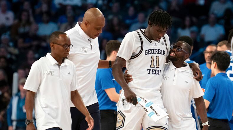 Georgia Tech forward Baye Ndongo (11) is helped off the court by training staff after an injury in the second half of an NCAA college basketball game against Duke, Saturday, Dec. 2, 2023, in Atlanta. (AP Photo/Hakim Wright Sr.)