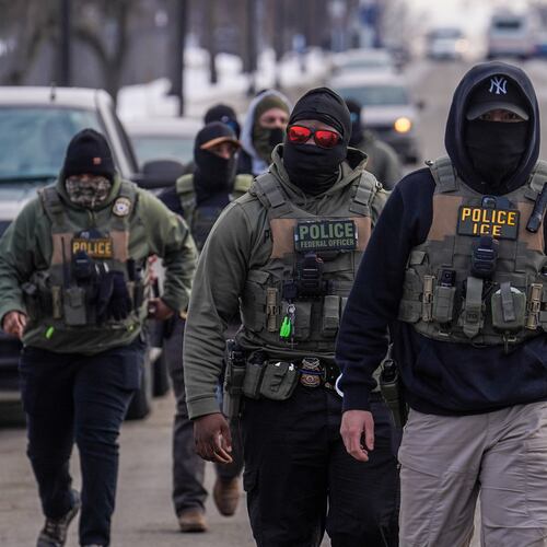 FILE - Federal agents walk down a street while conducting immigration enforcement operations, Thursday, Feb. 5, 2026, in Minneapolis. (AP Photo/Ryan Murphy, File)