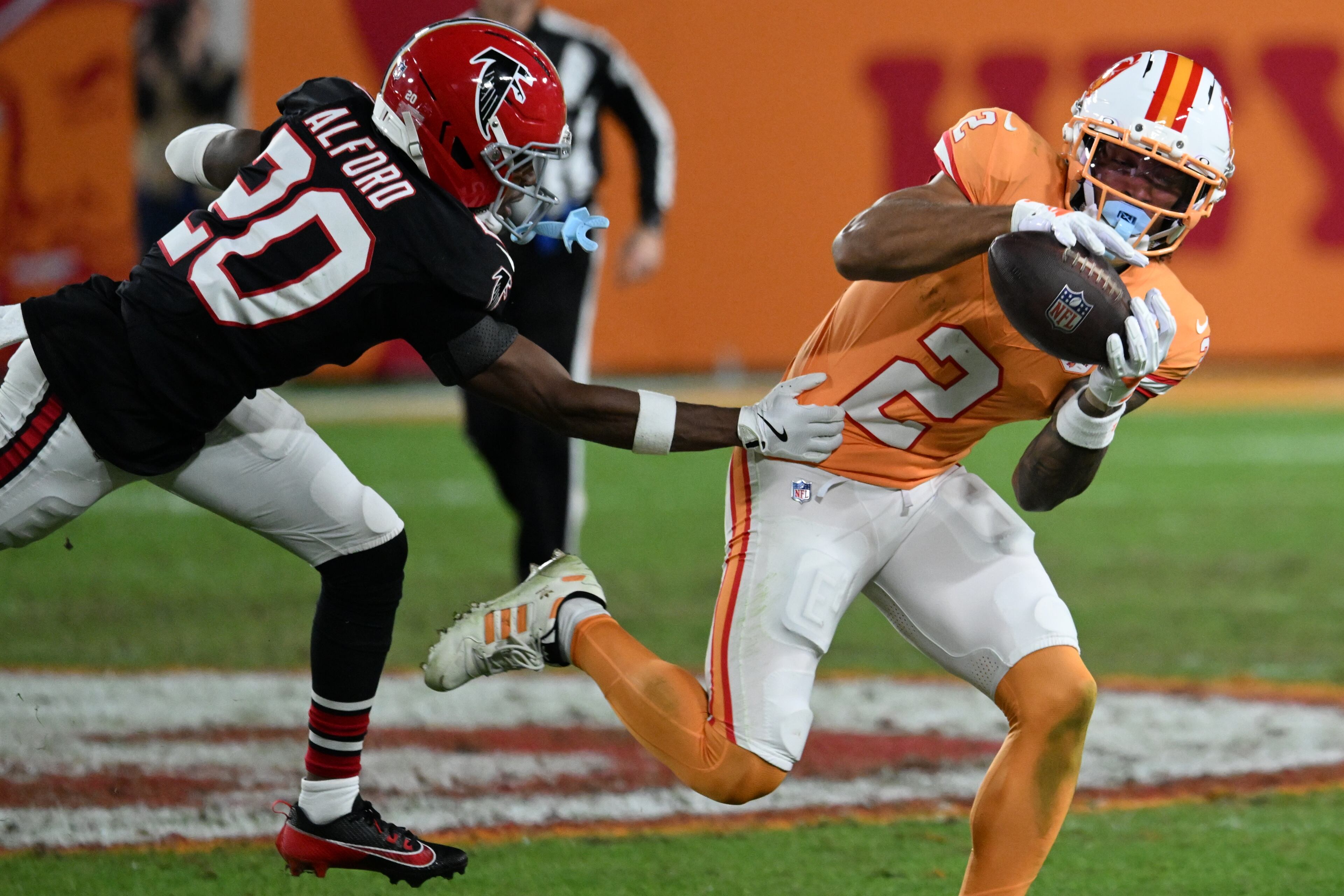 Tampa Bay Buccaneers wide receiver Emeka Egbuka (2) makes a catch against Atlanta Falcons cornerback Dee Alford (20) during the second half of an NFL football game, Thursday, Dec. 11, 2025, in Tampa, Fla. (AP Photo/Jason Behnken)