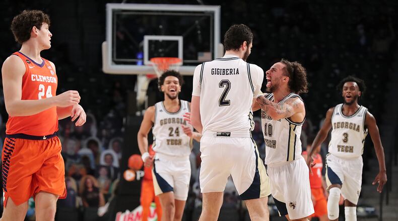 Georgia Tech center Rodney Howard (from left) looks on as Saba Gigiberia gets a chest bump from Jose Alvarado after hitting a 3-pointer against Clemson in the final minutes of a 83-65 upset victory with Bubba Parham rushing to join the celebration Tuesday, Jan. 20, 2021, in Atlanta. At left Clemson forward PJ Hall looks on. Curtis Compton / Curtis.Compton@ajc.com”
