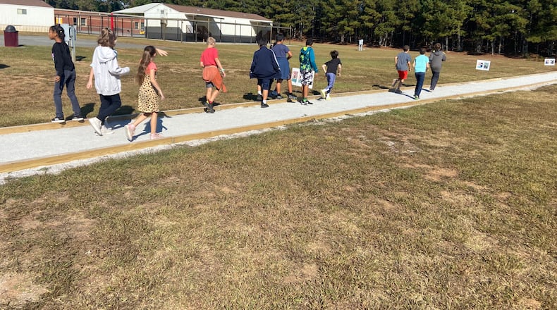 The "Story Walk" track at Holly Springs Elementary is lined with storyboards and exercise suggestions.
