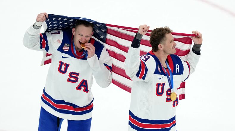 FILE - United States' Brady Tkachuk (7) and Matthew Tkachuk (19) celebrate after the United States' win over Canada in the men's ice hockey gold medal game at the 2026 Winter Olympics in Milan, Italy, Feb. 22, 2026. (AP Photo/Carolyn Kaster, File)