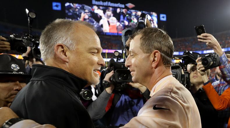 Miami's Mark Richt, left, congratulates Clemson's Dabo Swinney on a thorough whipping Saturday night. (Streeter Lecka/Getty Images)