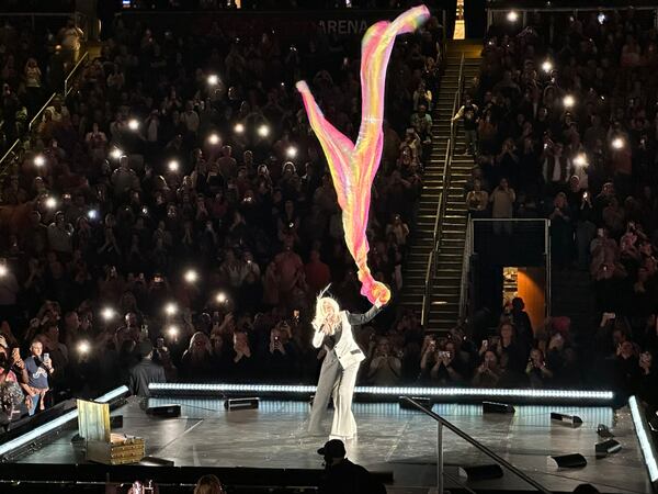 Cyndi Lauper uses artist Daniel Wertzel's "Air Fountain" installation in the center of State Farm Arena to maneuver a multi-colored sheet during "True Colors" as part of her encore Nov. 10, 2024. RODNEY HO/rho@ajc.com