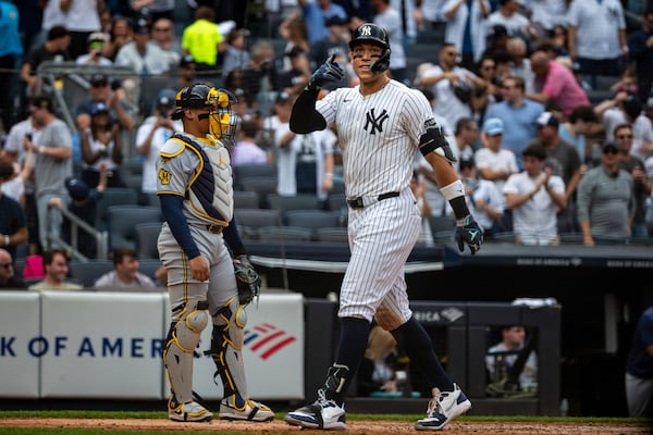 New York Yankees' Aaron Judge (99) celebrates his two-run home run in the fourth inning of a baseball game against the Milwaukee Brewers, Saturday, March 29, 2025, in New York. (AP Photo/Angelina Katsanis)