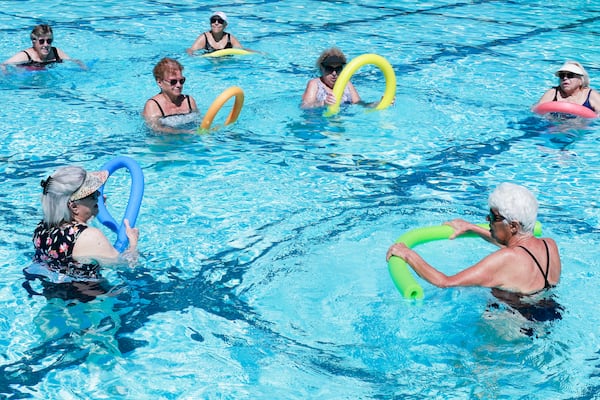 Sue Ottosen (bottom right) teaches a senior water aerobics class at Roswell Area Park Pool on Monday, July 24, 2023. (Natrice Miller/AJC)