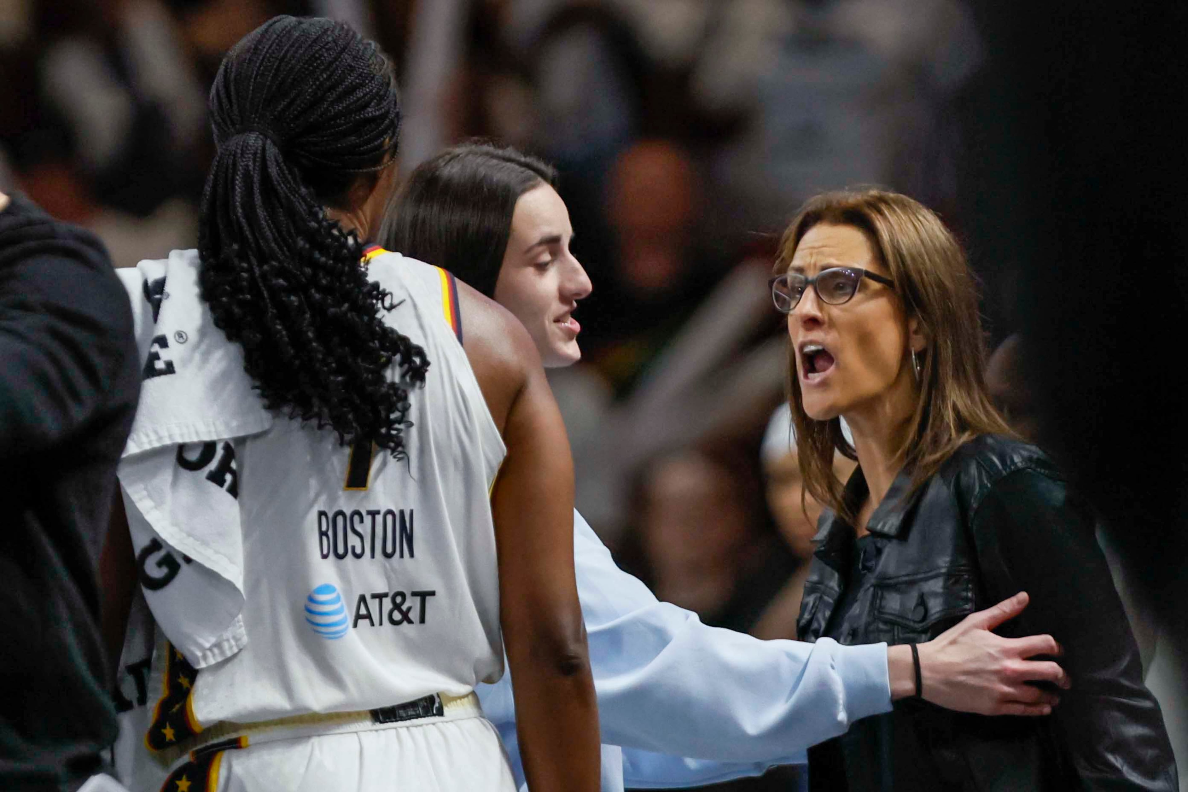Indiana Fever guard Caitlin Clark (22), center, tries to calm Indiana Fever head coach after a technical foul during the second half of a WNBA playoff game at Gateway Center Arena on Sunday, Sept. 14, 2024, in Atlanta. (Miguel Martinez/ AJC)