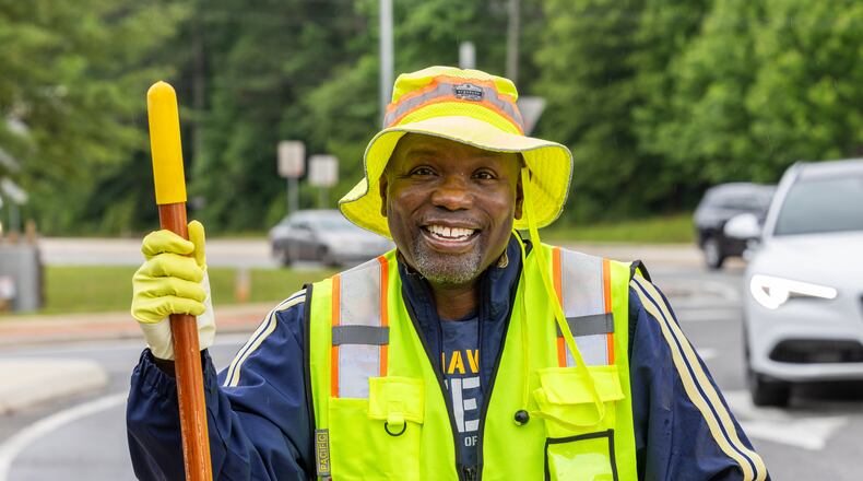 Anthony "Spark Plug" Thomas cleans up litter and debris at the Highway 92 traffic circle at Antioch and Lockwood roads in Fayetteville. He is a nationally recognized motivational speaker and U.S. Navy Veteran based in Fayetteville, Georgia, is making waves with his commitment to community cleanliness. PHIL SKINNER FOR THE ATLANTA JOURNAL-CONSTITUTION