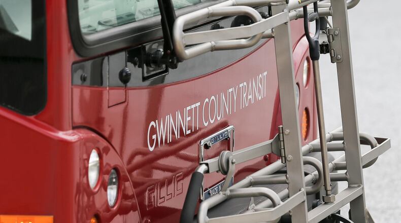 The exterior of a Gwinnett County Transit bus is displayed at a Gwinnett County Transit bus center near Gwinnett Place Mall in Duluth. County commissioners have agreed to a transit project list that includes more expansion than they can afford. (ALYSSA POINTER/ALYSSA.POINTER@AJC.COM) AJC FILE PHOTO