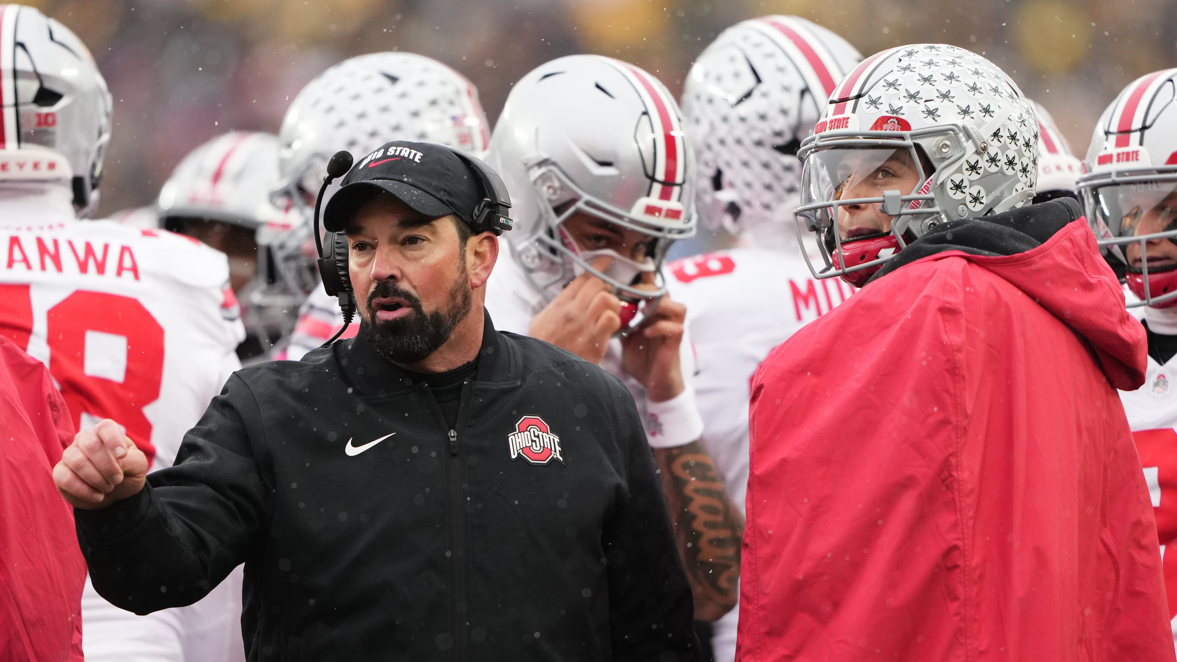 Ohio State head coach Ryan Day, left, speaks with quarterback Julian Sayin during the first half of an NCAA college football game against Michigan, Saturday, Nov. 29, 2025, in Ann Arbor, Mich. (AP Photo/Ryan Sun)