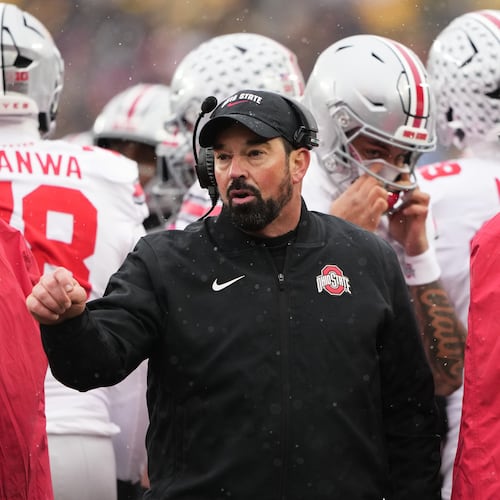 Ohio State head coach Ryan Day, left, speaks with quarterback Julian Sayin during the first half of an NCAA college football game against Michigan, Saturday, Nov. 29, 2025, in Ann Arbor, Mich. (AP Photo/Ryan Sun)
