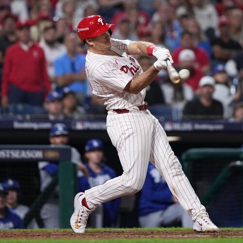 FILE - Philadelphia Phillies' J.T. Realmuto hits a double during the ninth inning in Game 2 of baseball's National League Division Series against the Los Angeles Dodgers, Monday, Oct. 6, 2025, in Philadelphia. (AP Photo/Matt Slocum, File)