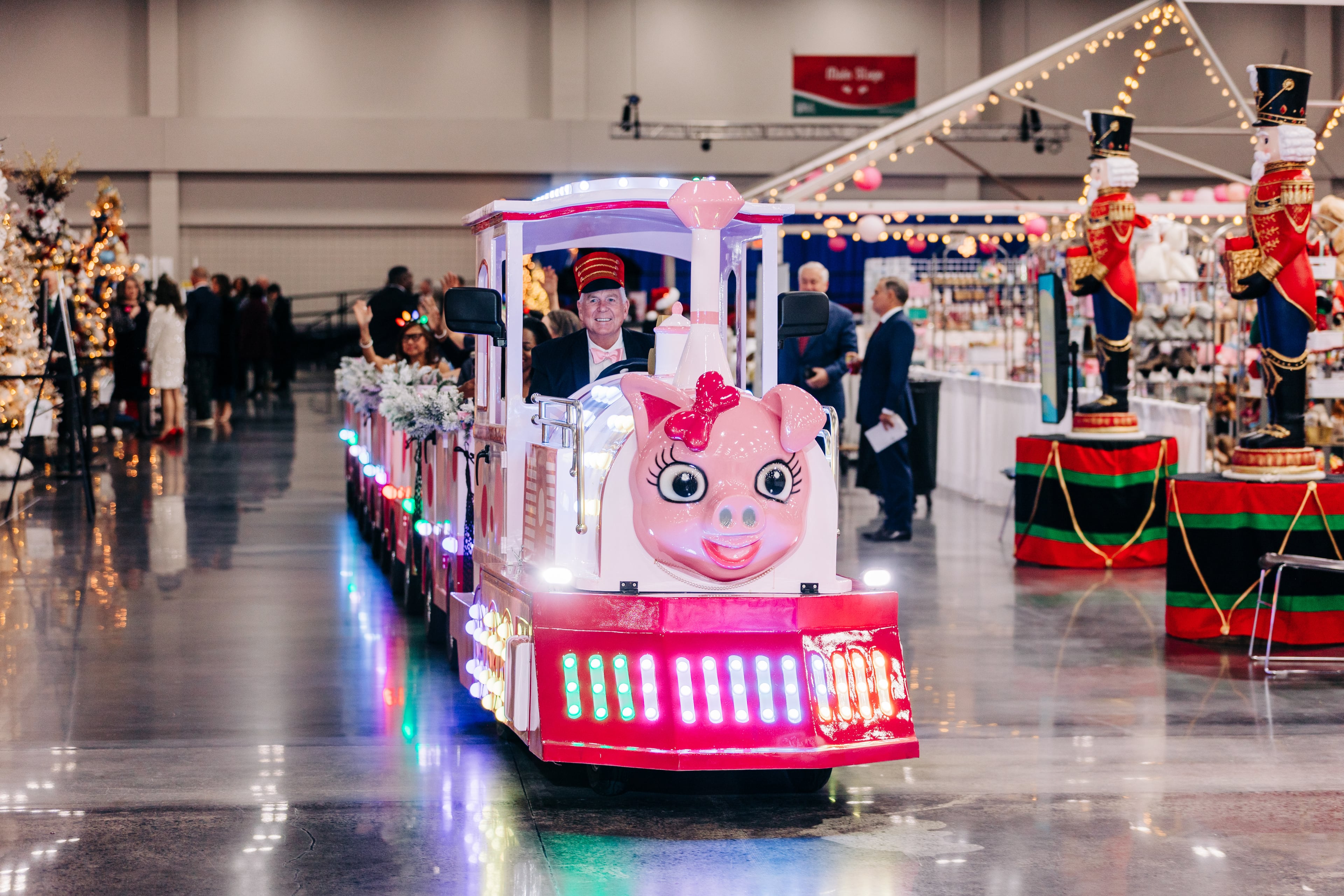 Riding the Pink Pig is a favorite festival adventure. Georgia Festival of Trees starts Nov. 22 at the Gas South Convention Center in Duluth. (Courtesy of Georgia Festival of Trees)