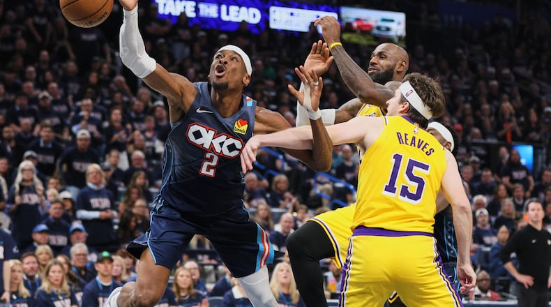 Oklahoma City Thunder's Shai Gilgeous-Alexander (2) is fouled driving to the basket by Los Angeles Lakers' Austin Reaves (15) as LeBron James, right rear, follows behind on the play in the second half of Game 2 in a second-round NBA basketball playoffs series Thursday, May 7, 2026, in Oklahoma City. (AP Photo/Nate Billings)