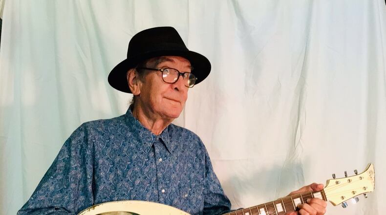 Bob Hay, founder of Athens band Squalls is pictured holding his unique Apollo Guitar - in a photograph taken August 3, 2022. 
(Courtesy of Vanessa Briscoe Hay.)