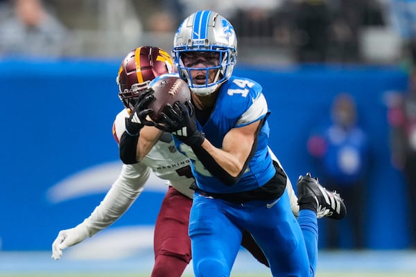 FILE - Detroit Lions wide receiver Amon-Ra St. Brown (14) catches a pass against the Washington Commanders during the first half of an NFL football divisional playoff game, Saturday, Jan. 18, 2025, in Detroit. (AP Photo/Seth Wenig, File)