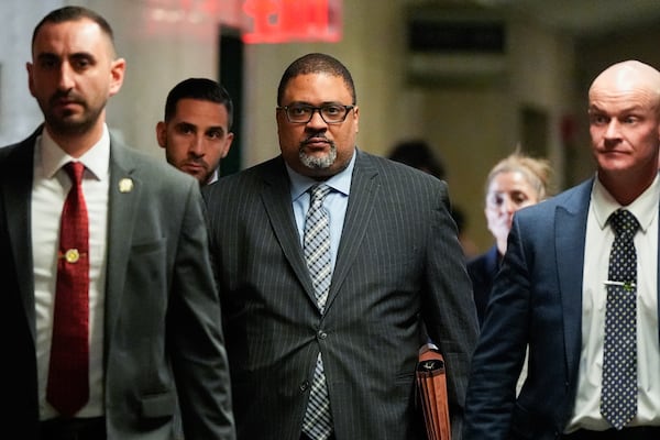 Manhattan district attorney Alvin Bragg, center, walks through Manhattan criminal court, Tuesday, April 22, 2025, the day of Harvey Weinstein's retrial in New York. (AP Photo/Julia Demaree Nikhinson)