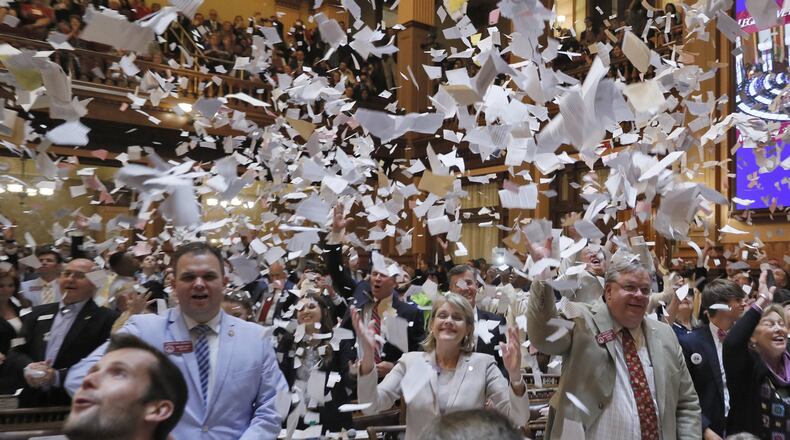 House members toss papers in the air as Sine Die was proclaimed shortly after midnight. Thursday was the 40th and final day of the 2018 General Assembly. BOB ANDRES /BANDRES@AJC.COM