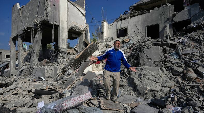 A man reacts on the rubble of a destroyed home that was hit by an Israeli airstrike in Ansar village, southern Lebanon, Saturday, Aug. 15, 2026. (AP Photo/Mohammed Zaatari)