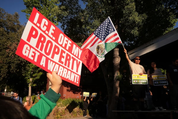Residents gather during a community vigil on Monday, June 30, 2025, to stand in solidarity with an immigrant family after ICE agents detained Rosalina Luna Vargas on Saturday, June 28, in front of her children, in Pasadena, Calif. (AP Photo/Damian Dovarganes)